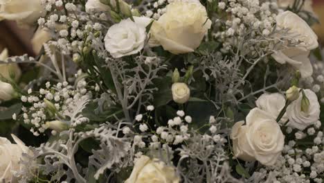 delicate white floral arrangement featuring roses and baby's breath, creating a serene and elegant display