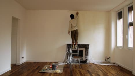 skilled man painter working inside a newly renovated space