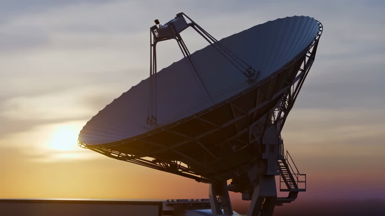 Large satellite dish silhouetted against a sunset or sunrise sky