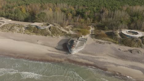 An-aerial-view-of-an-abandoned-WW2-defense-bunker-with-cannon-emplacements-on-the-Baltic-Seashore