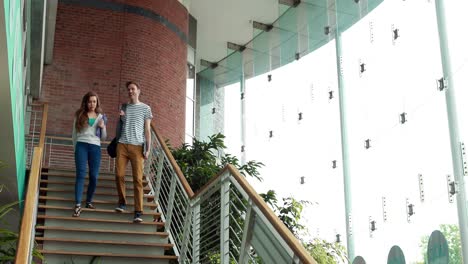 friends speaking and going down the stairs