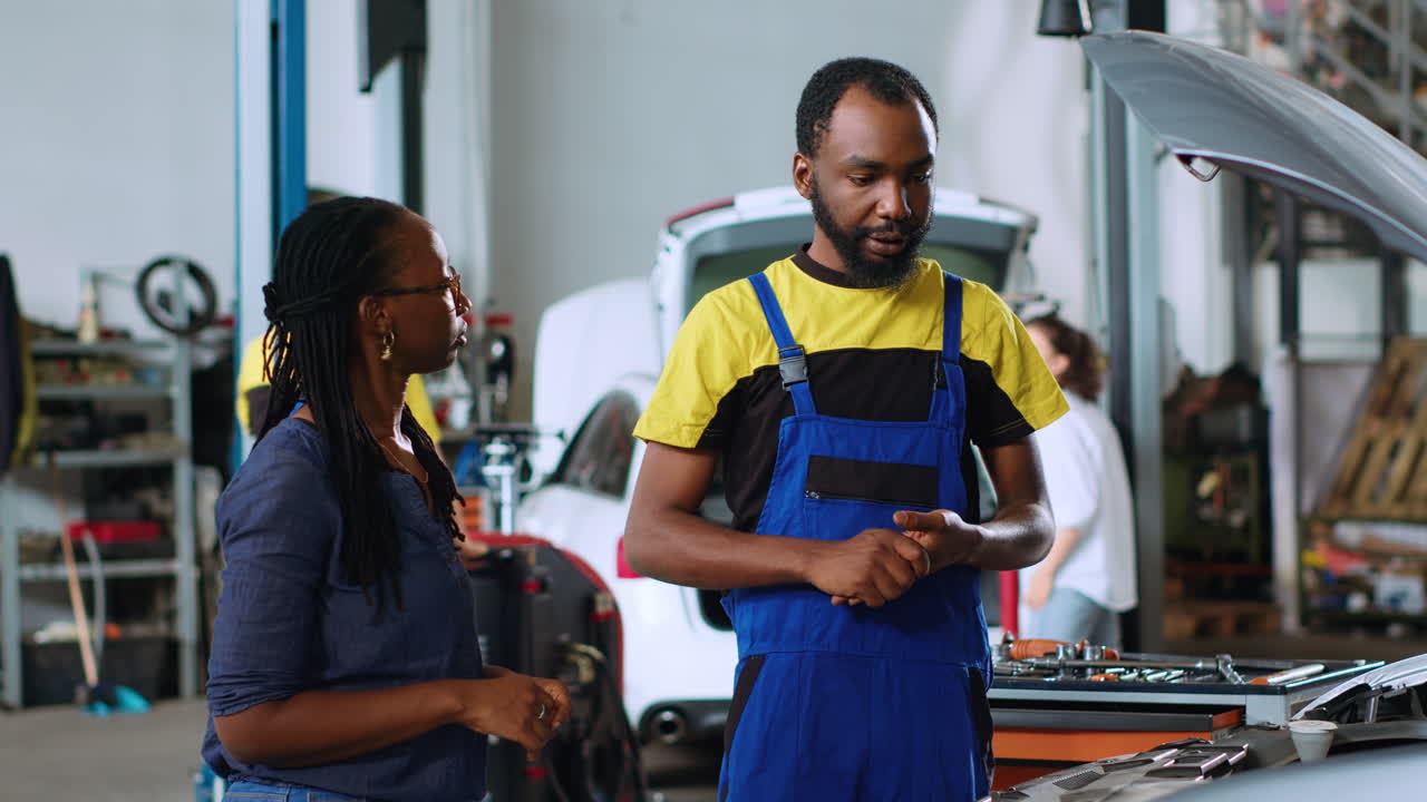 Professional showing client car damages