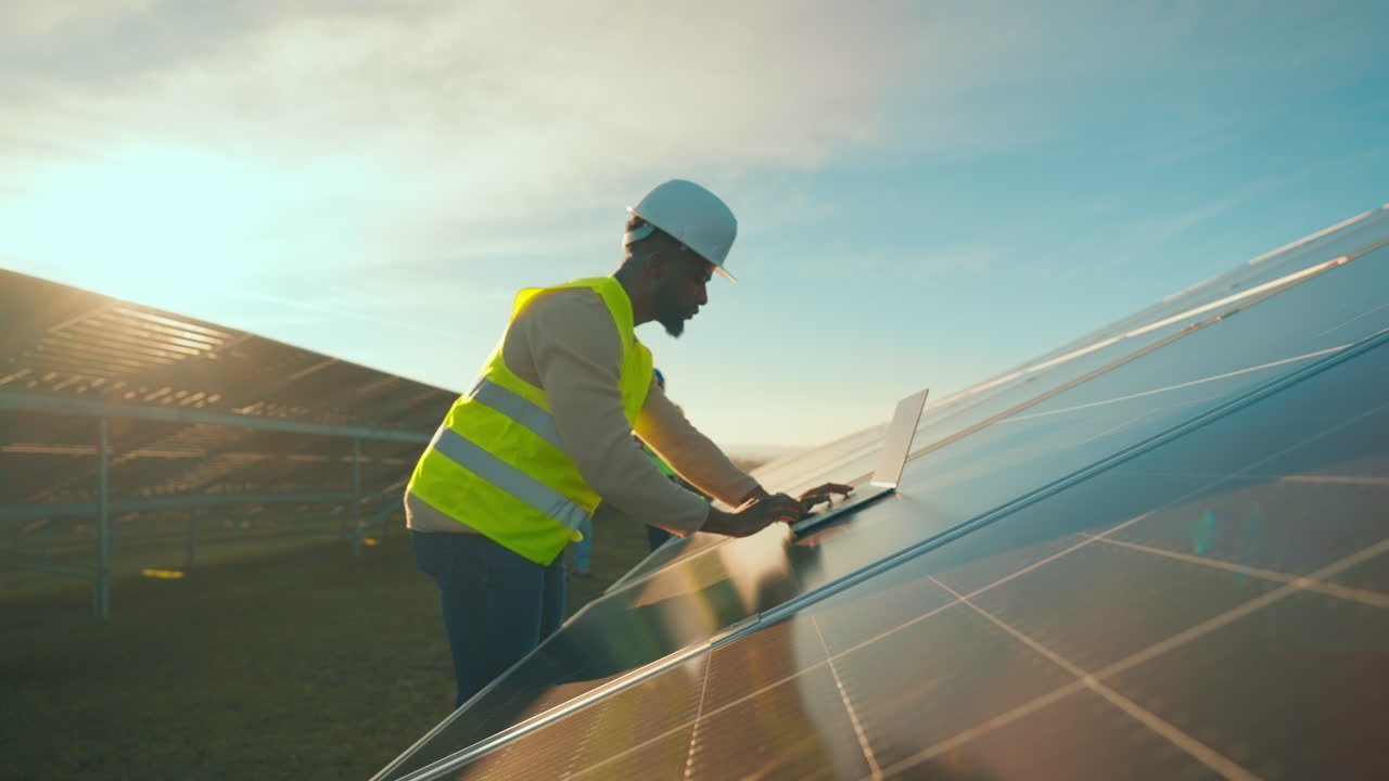 Engineer Inspecting Solar Panels at Solar Farm