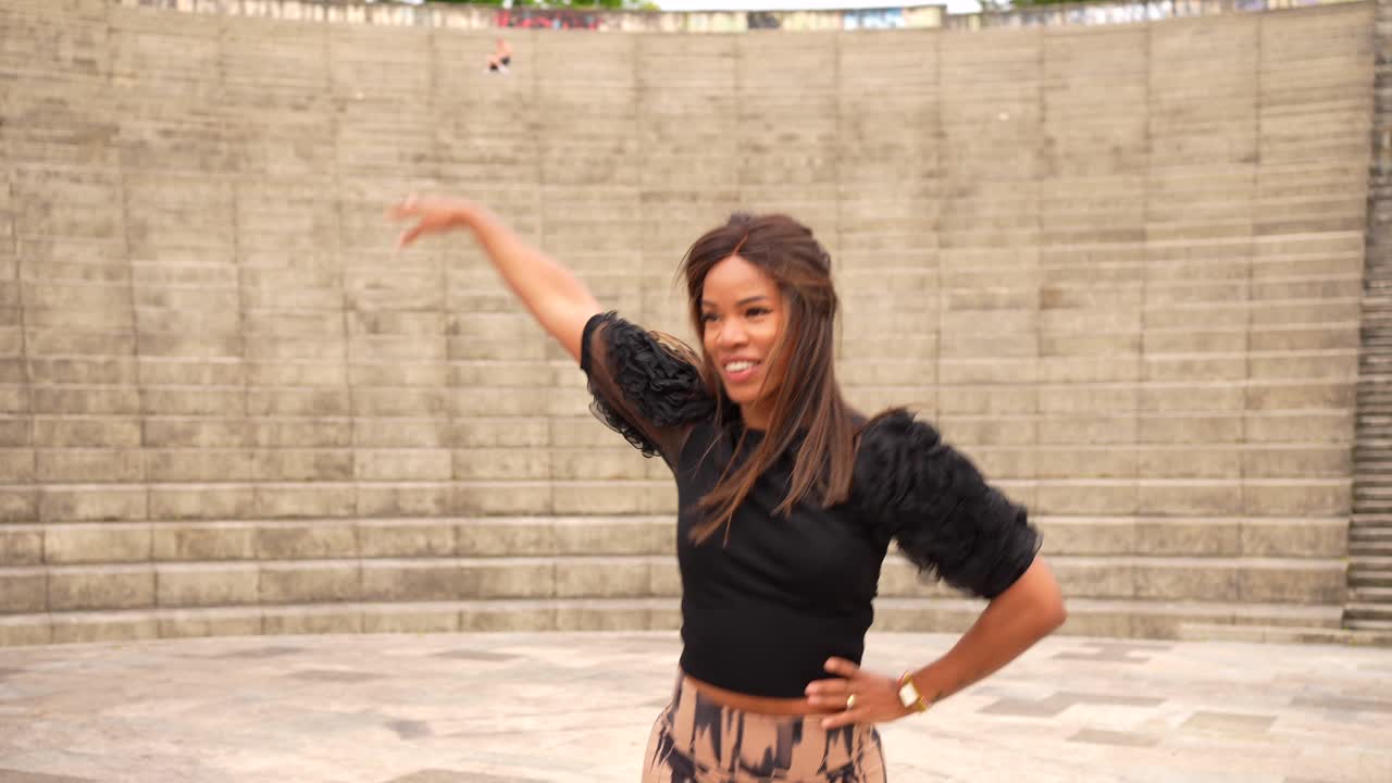 Woman dancing in front of a staircase