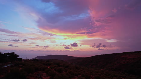 stunning sunset over hills with vibrant clouds near a coastal area