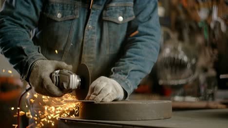 locksmith cuts sheet metal with a grinder with a lot of sparks in slow motion, metalwork at workshop, 4k 60p prores hq