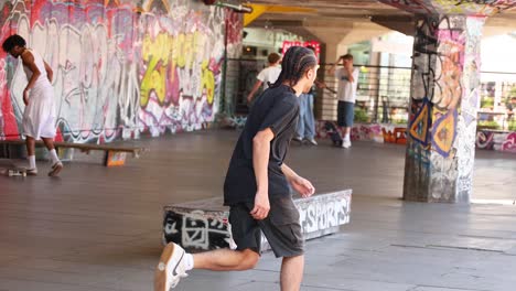 skateboarders performing tricks in urban graffiti park