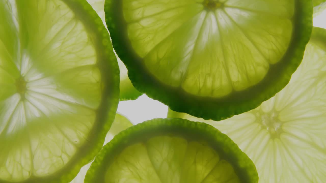 Camera zooming causing translucent lime slices shifting while white HUDs sliding revealing data