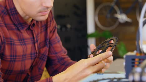 mechanic checking chain ring in workshop 4k