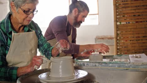 male and female potter working together