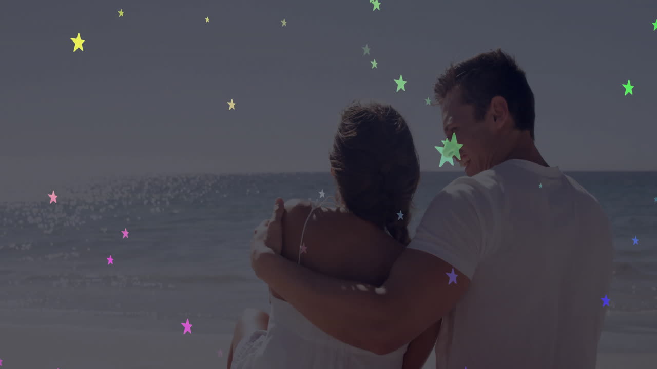 Embracing on beach, couple with colorful star animation overlay, enjoying moment