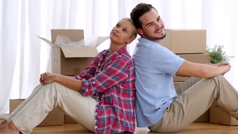couple sitting back-to-back