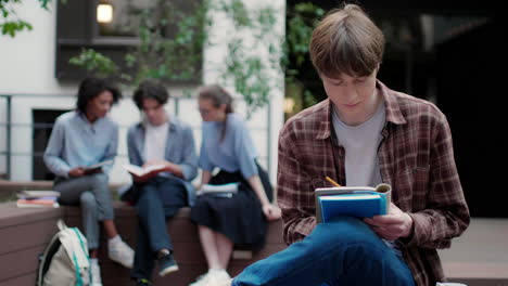 caucasian thoughtfull boy in university campus.