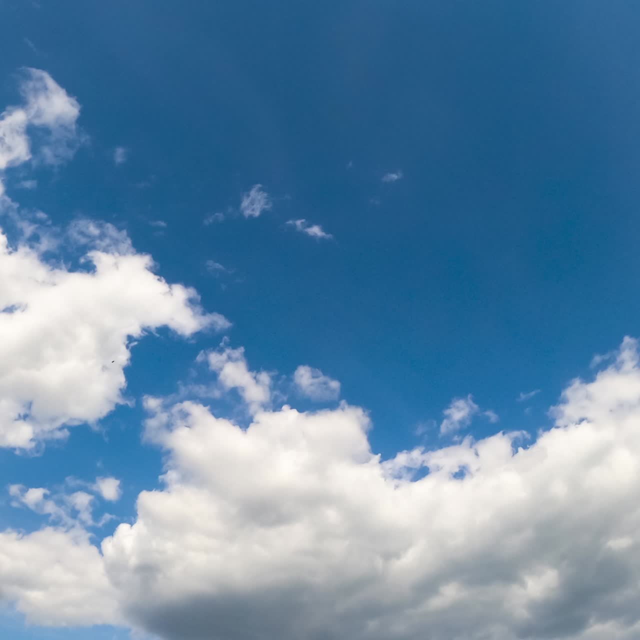 Motion of clouds on the sky. Blue bright weather timelapse
