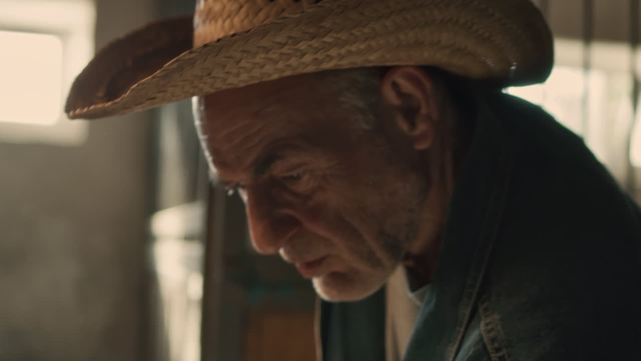 Old Farmer in a Stable