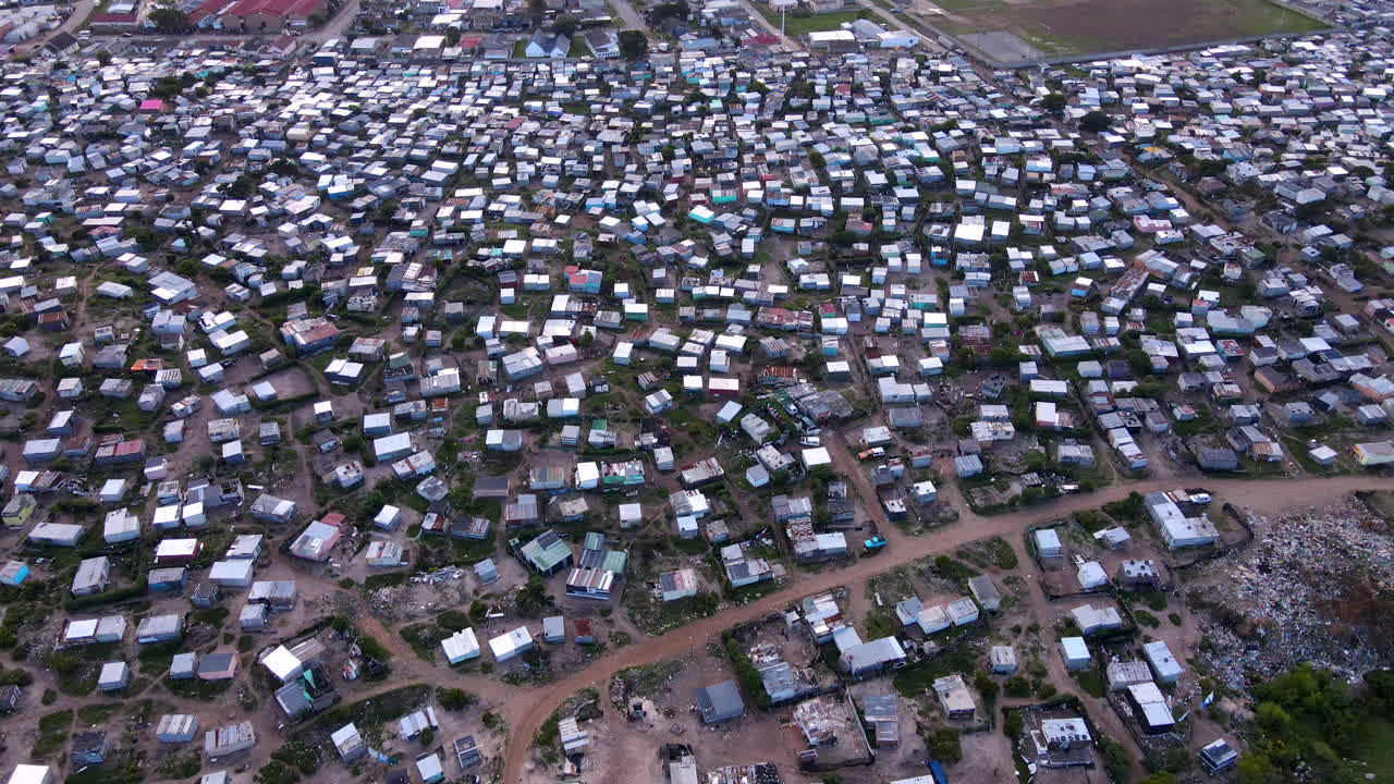 Shanty town with makeshift improvised buildings clustered together, aerial view