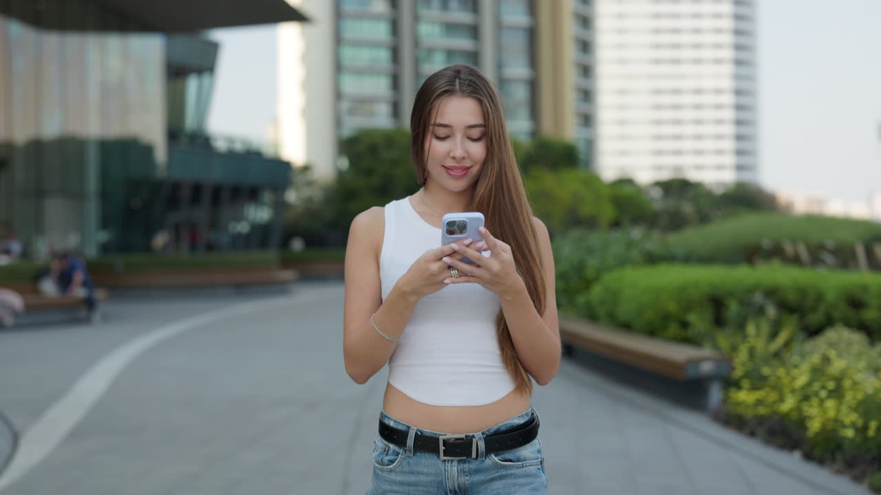 Young Woman Using Smartphone in Urban Environment