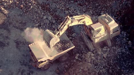 static shot of a large excavators unloading rocks