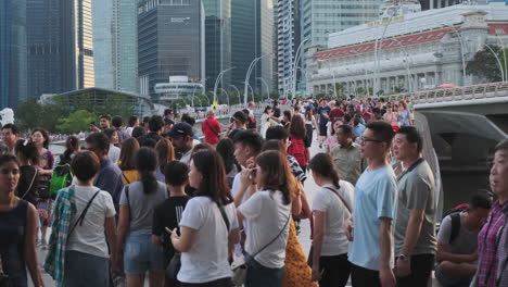 people walking on a bridge in singapore city