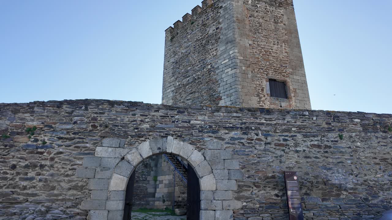 Portuguese flag waving over the keep of Monsaraz Castle, a medieval fortress located in the picturesque village of Monsaraz, Alentejo region