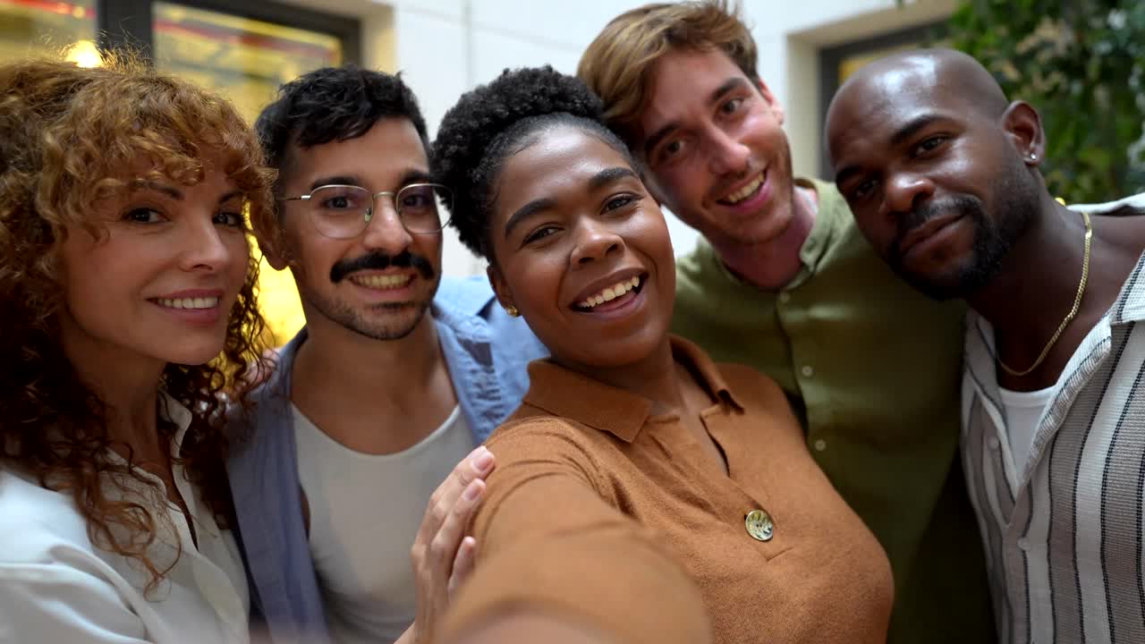 Um grupo diverso de amigos felizes tirando uma selfie juntos