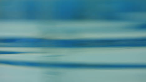 Abstract-water-background.-Blue-water-wave.-Closeup-of-smooth-water-surface