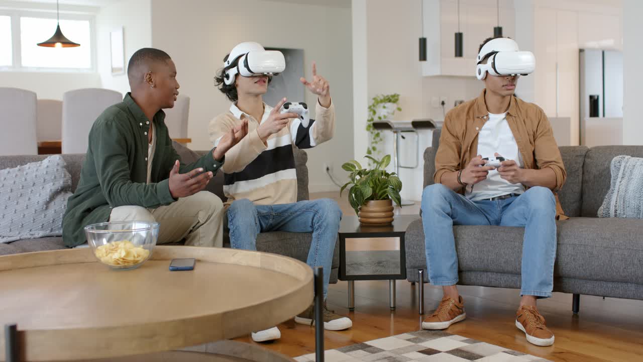 Diverse male friends at game start using VR gear for gaming on sofa as observer commenting