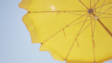 yellow beach umbrella under a clear sky