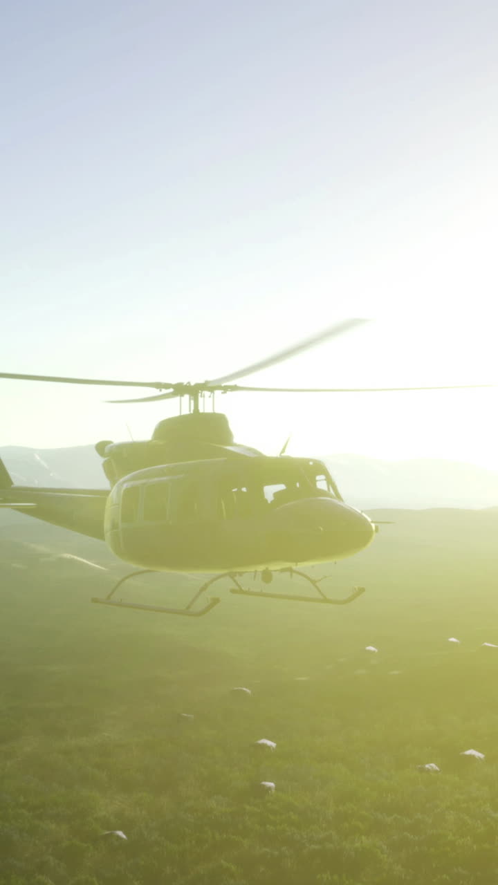Helicopter soaring into the golden embrace of a serene sunrise over mountains