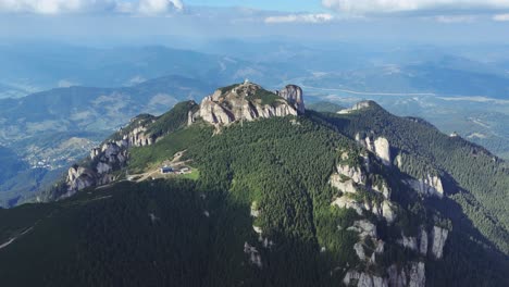 aerial view of a mountain range with lush green forest