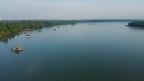 Aerial-View-of-Bagan-Lalang-river-in-the-morning-with-floating-houses,-Malaysia