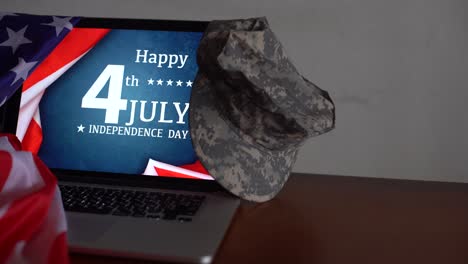 laptop with inscription happy independence day on usa flag.