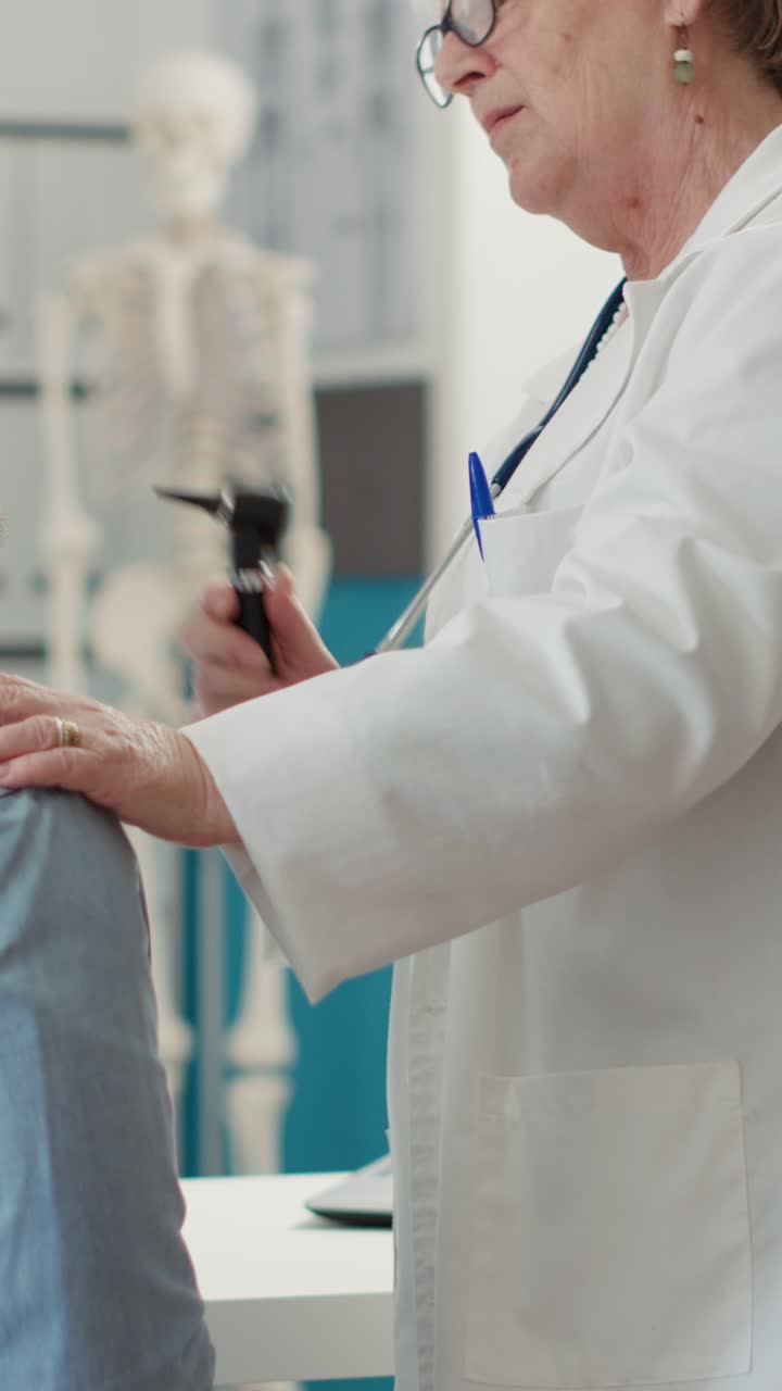 Doctor performing ear examination on patient
