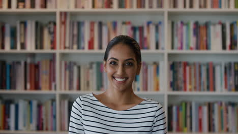 portrait-beautiful-young-indian-woman-student-smiling-enjoying-successful-education-business-ambitious-female-looking-happy-in-library-bookstore-background-slow-motion