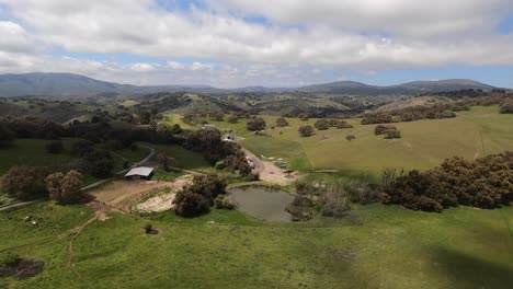 Aerial-view-chasing-a-black-helicopter-over-the-hills-near-Santa-Ysabel,-California