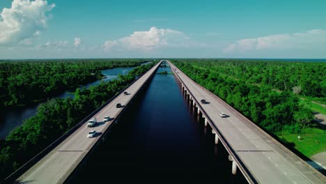 twin elevated highways stretch across louisiana’s lush wetlands, blending engineered precision with the raw beauty of bayou wilderness