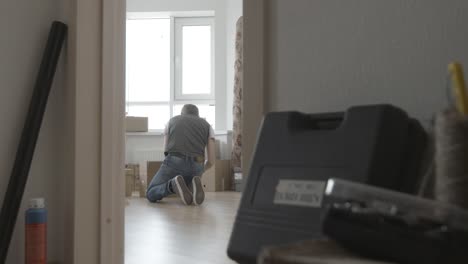 man packing boxes in new apartment