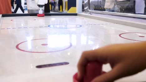 robot playing air hockey