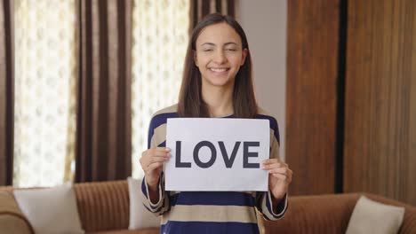 happy indian woman holding love banner