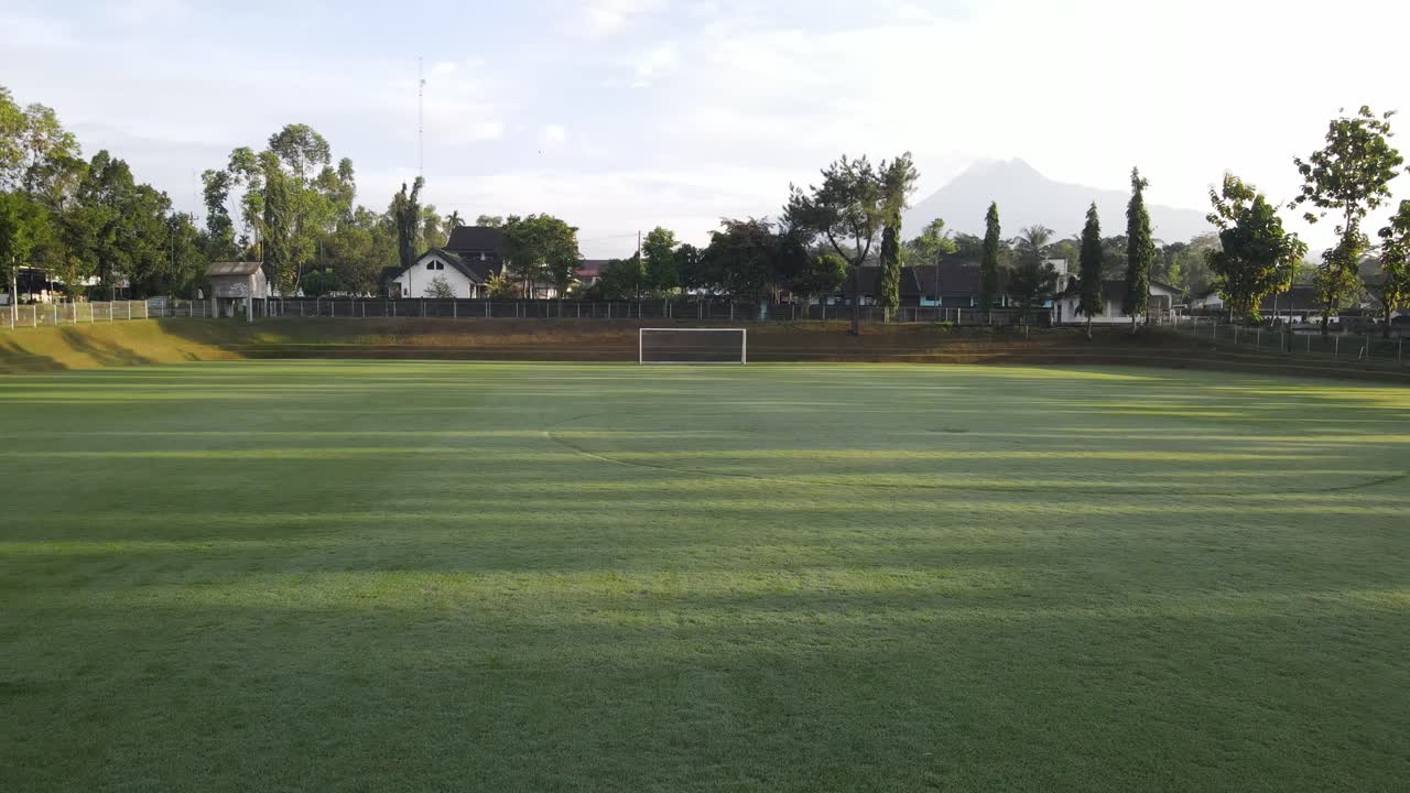 Purwobinangun Sports Field in Yogyakarta with a beautiful backdrop of Mount Merapi in the morning.