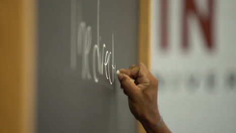 black prisoner african american inmate writing on chalkboard in slow motion shot on sony a7iii mirrorless camera