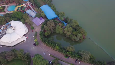 aerial view capturing a resort situated beside a lake in hyderabad, india during sunset.