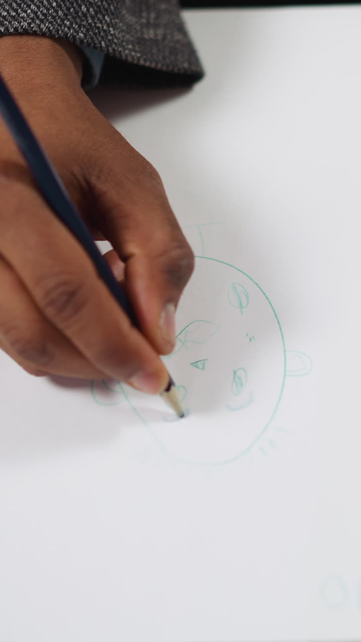 Black man tutor draws doubting face on paper to learn emotions in English with little girl student at private lesson upper closeup slow motion