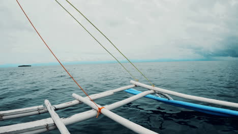 Slow-motion-shot-looking-out-to-an-empty-ocean-in-the-Philippines,-filmed-from-an-outrigger-boat