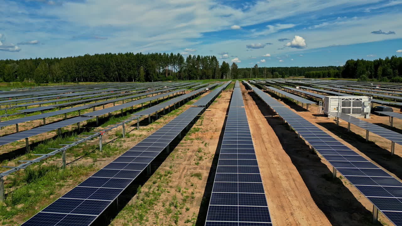 Motion view of large sustainable electrical power plant with many rows of solar photovoltaic panels for producing clean electric energy. Renewable electricity with zero emission concept. Aerial shot.