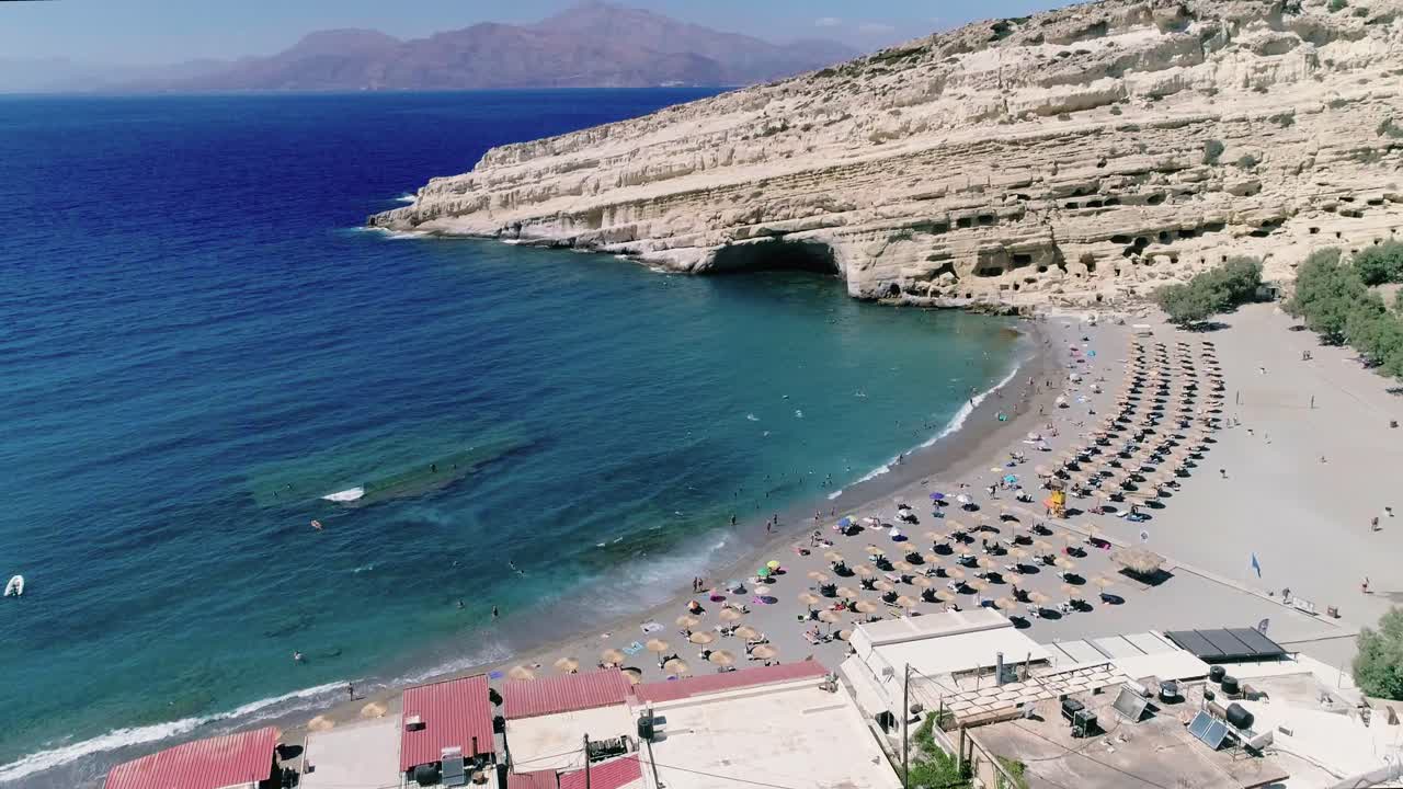 Beautiful view from a drone flying over the beach and bay in Matala Crete Greece