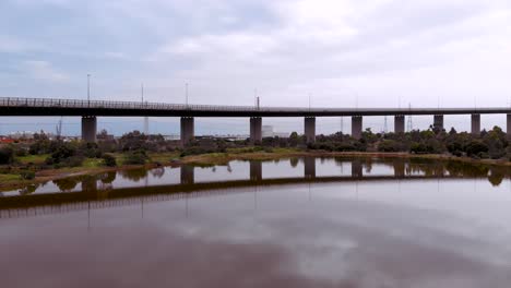 The-vibrant-wetland-and-nature-sanctuary-pink-lake-drone-shot-at-Westgate-Bridge-located-on-the-edged-of-the-city-in-Port-Melbourne