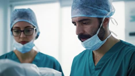 medical professionals engaged in critical procedure, focused on equipment and task at hand, demonstrating expertise in operating room environment