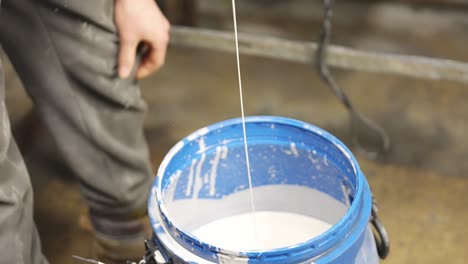 dripping paint into paint pot