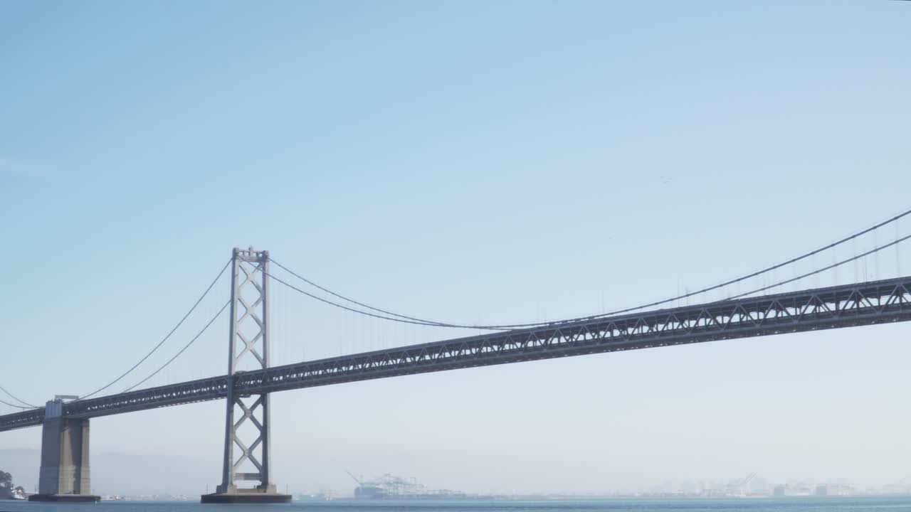 샌프란시스코에서 맑고 화창한 날 베이 브리지를 가로질러 이동하는 자동차의 패닝 샷
